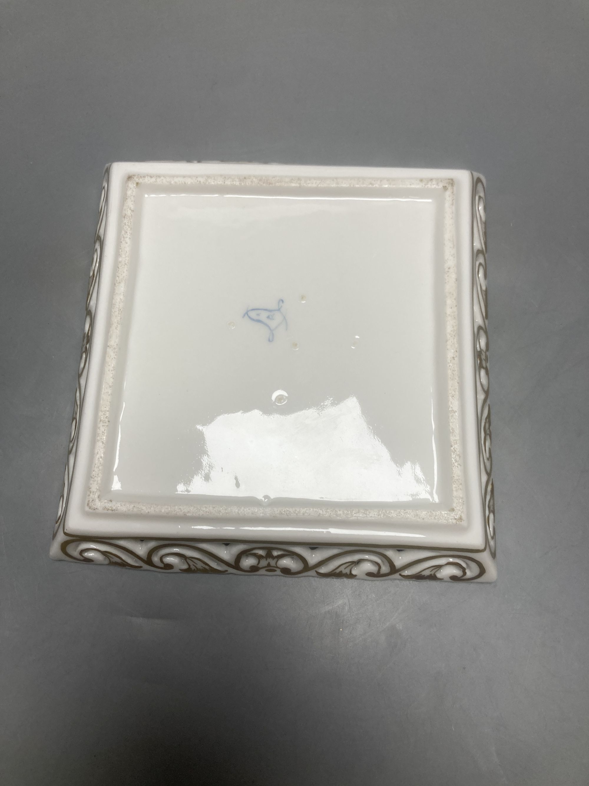 A Sevres square putti decorated dish, 15cm sq.